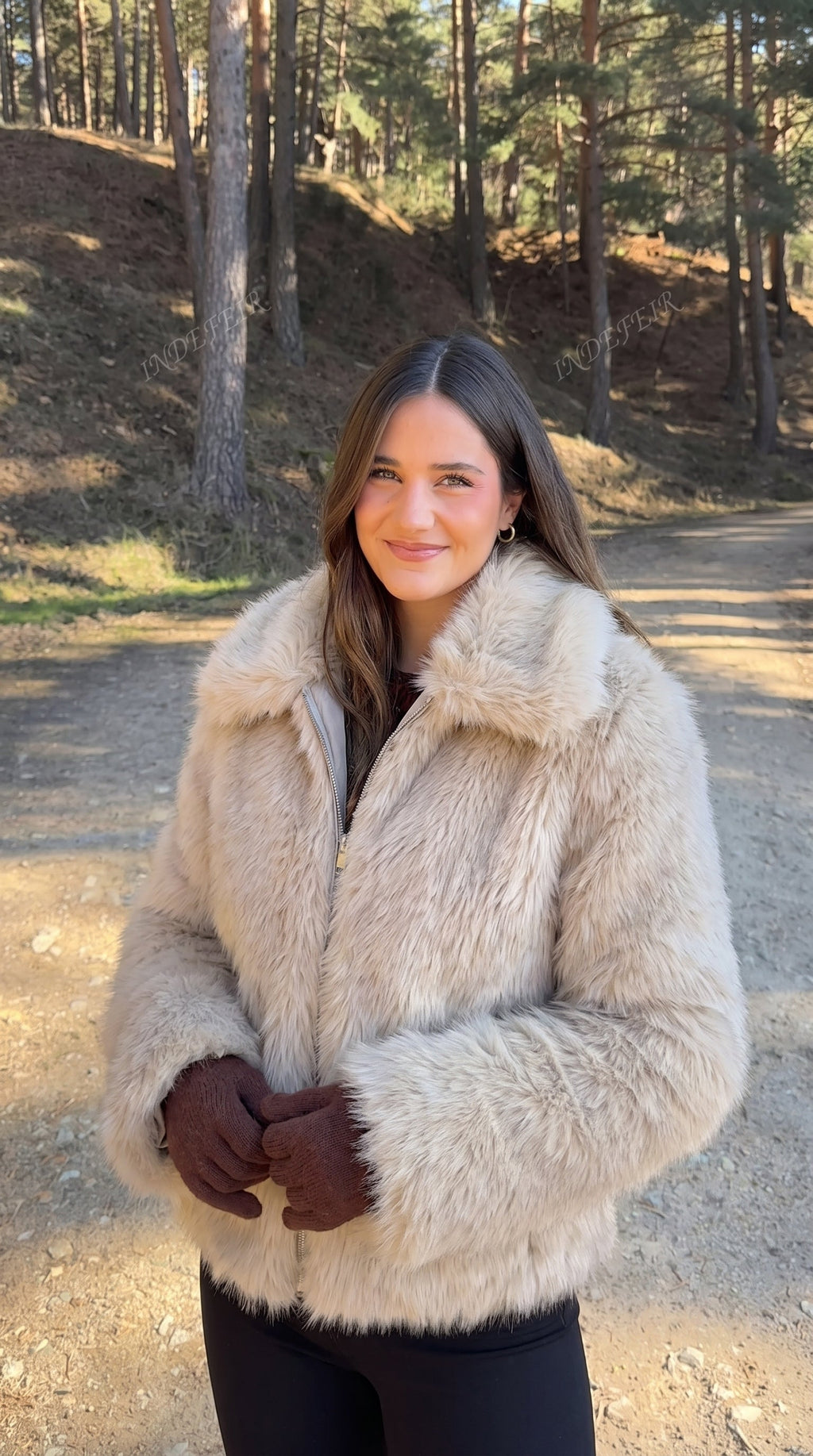 Woman wearing a beige faux fur bomber jacket with an oversized collar