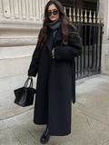 Woman wearing a long belted double-breasted trench coat