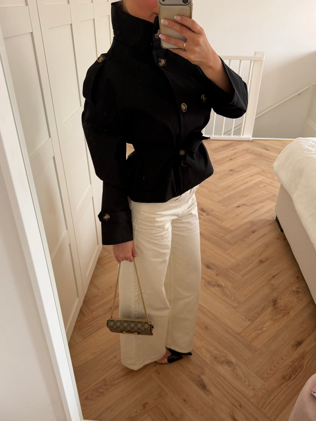 Women's black cropped trench jacket with high collar, buttons and tie belt