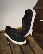 Low-top camouflage trainers with lace-up front and white sole