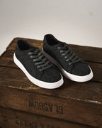 Low-top camouflage trainers with lace-up front and white sole