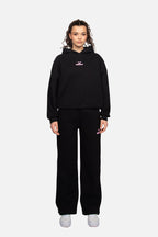 Women's black cropped hoodie with hood and pink chest logo