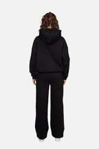 Women's black cropped hoodie with hood and pink chest logo