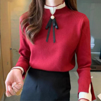 Women's long-sleeved mock neck jumper with pearl button and ribbon bow detail