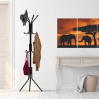 Black freestanding coat rack stand with multiple curved hooks and three-legged base