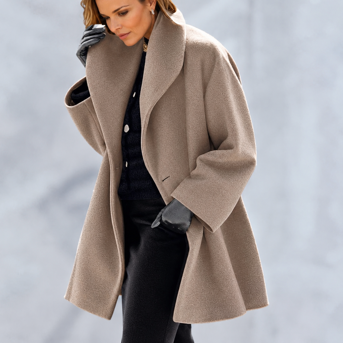 Woman wearing a long-sleeved shawl collar tailored jacket with an open front