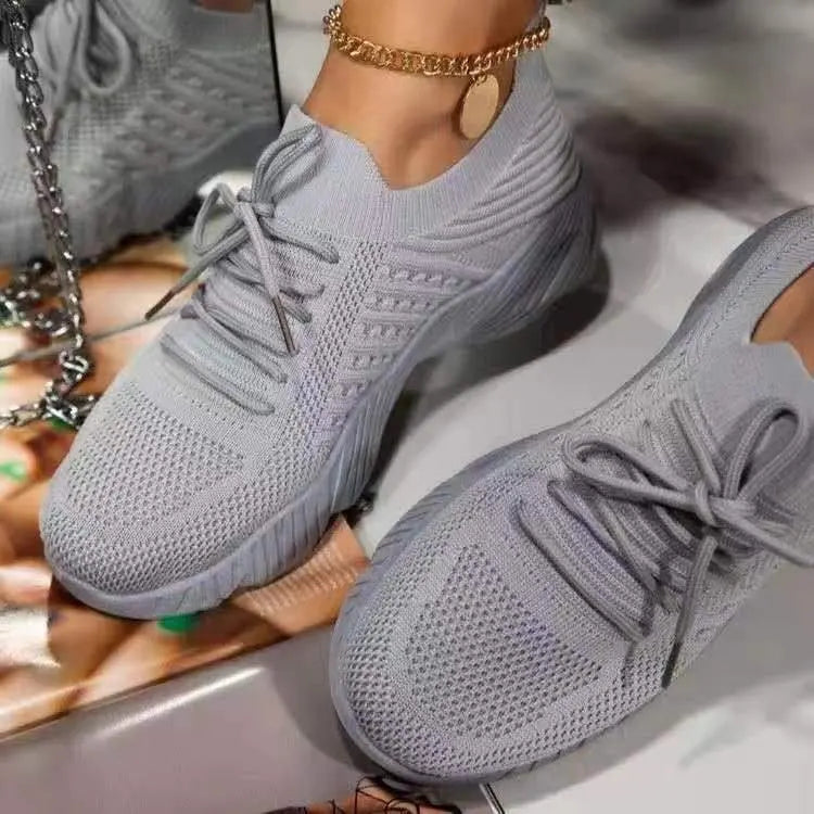 Women's lace-up walking sneakers with textured uppers and ridged flat soles