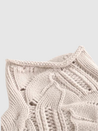 Cable knit turtleneck sweater with long sleeves and textured detailing