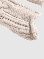 Cable knit turtleneck sweater with long sleeves and textured detailing