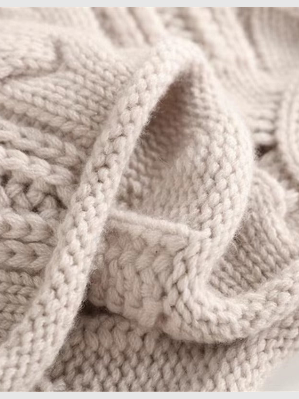 Cable knit turtleneck sweater with long sleeves and textured detailing