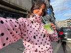 Women's pink cropped jacket with black polka dots, high collar and tie waist