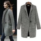 Women's long black and white herringbone coat with notched collar and button fastening
