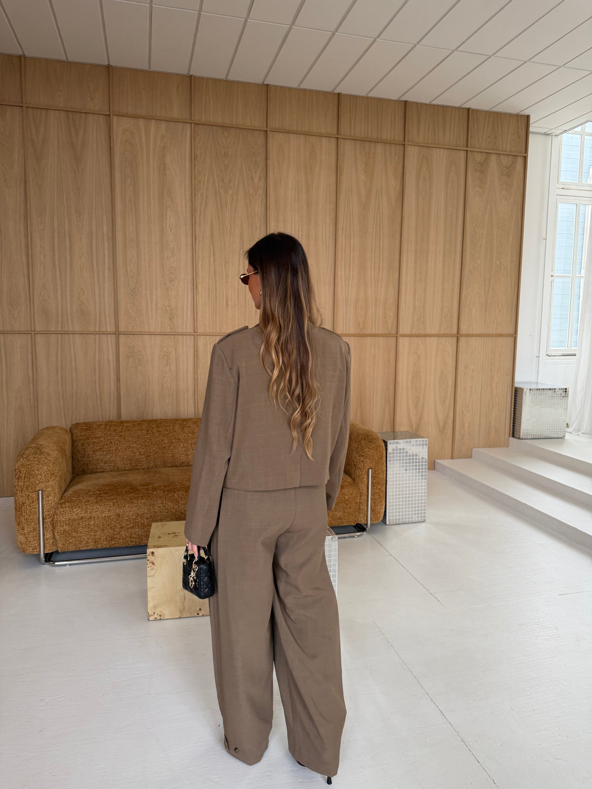Women's taupe tailored blazer with notch lapels, long sleeves and flap pockets