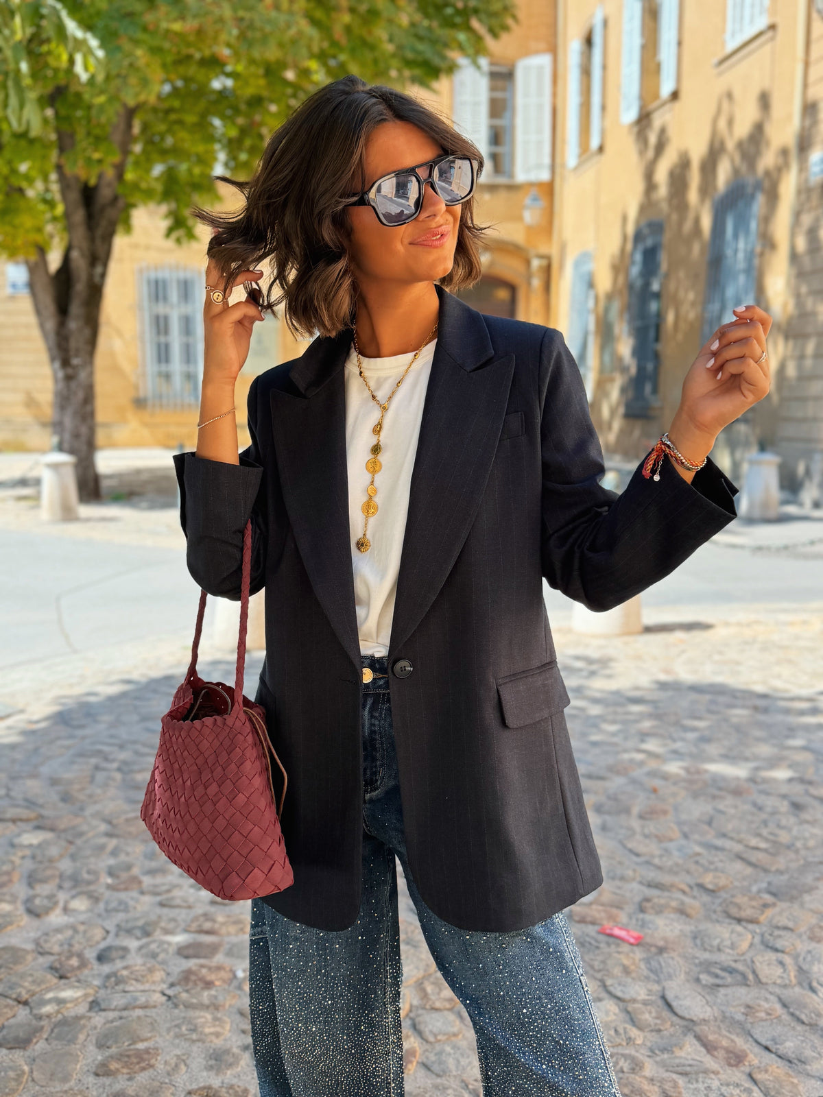 Women's black striped blazer with notched lapels and long sleeves
