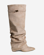 Women's beige slouchy knee-high boots with pointed toes, low heels and buckle straps
