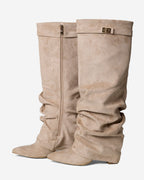 Women's beige slouchy knee-high boots with pointed toes, low heels and buckle straps
