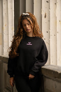 Women's black crewneck sweatshirt with pink butterfly logo and long sleeves