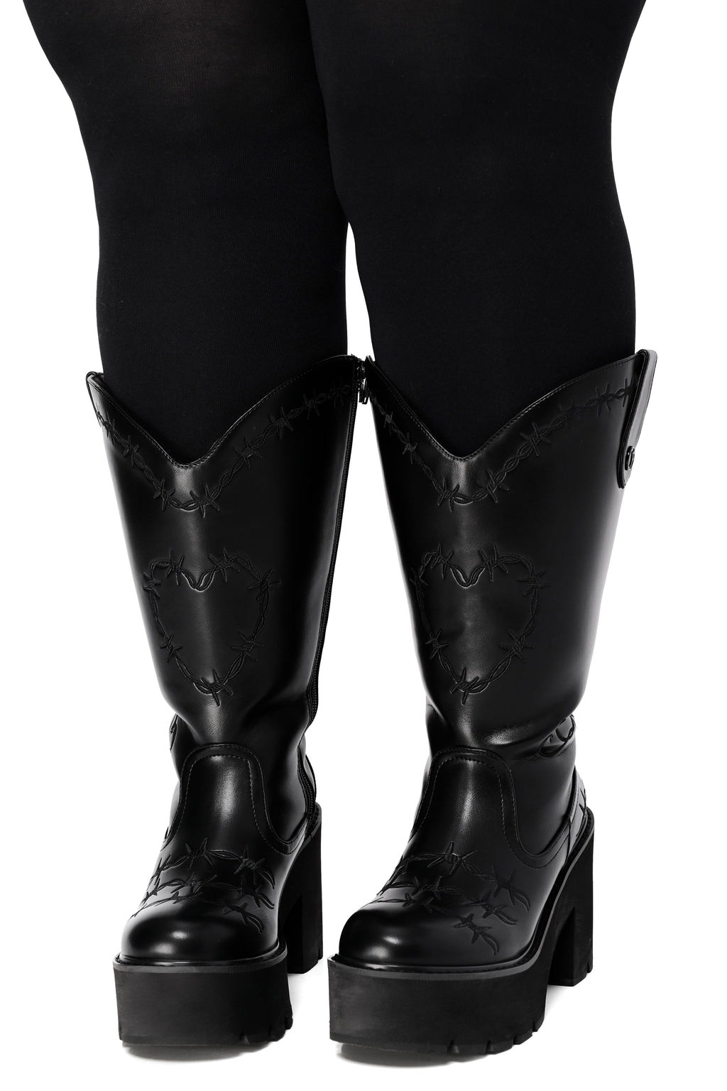 Black platform cowboy boots with barbed wire stitching and buckle straps
