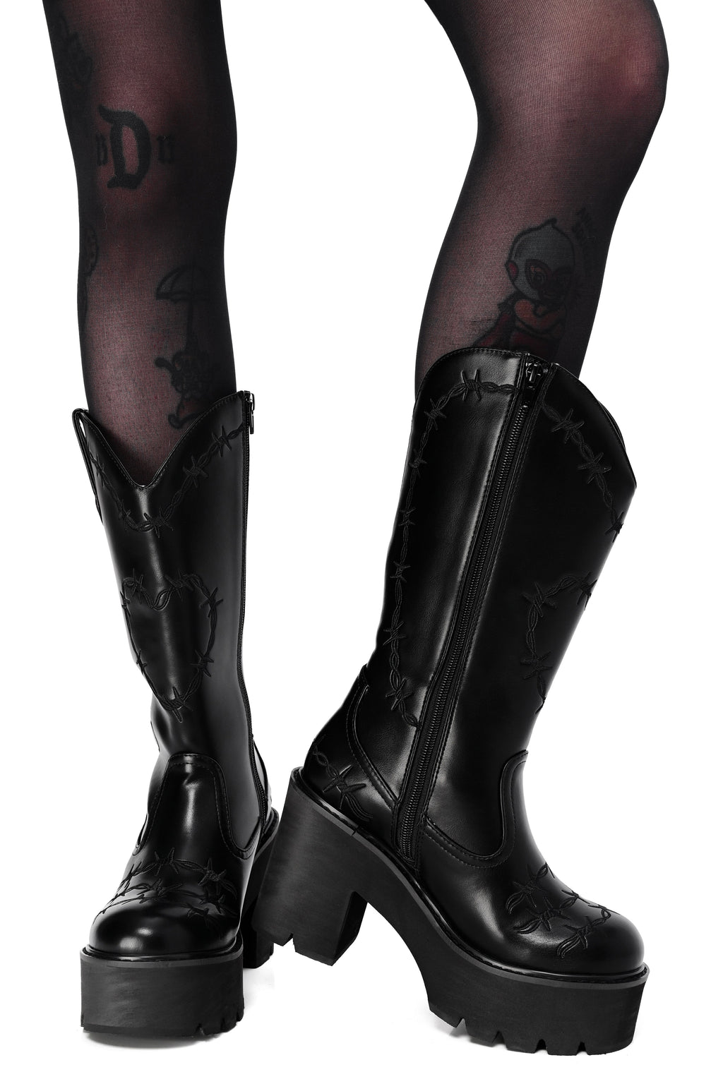 Black platform cowboy boots with barbed wire stitching and buckle straps