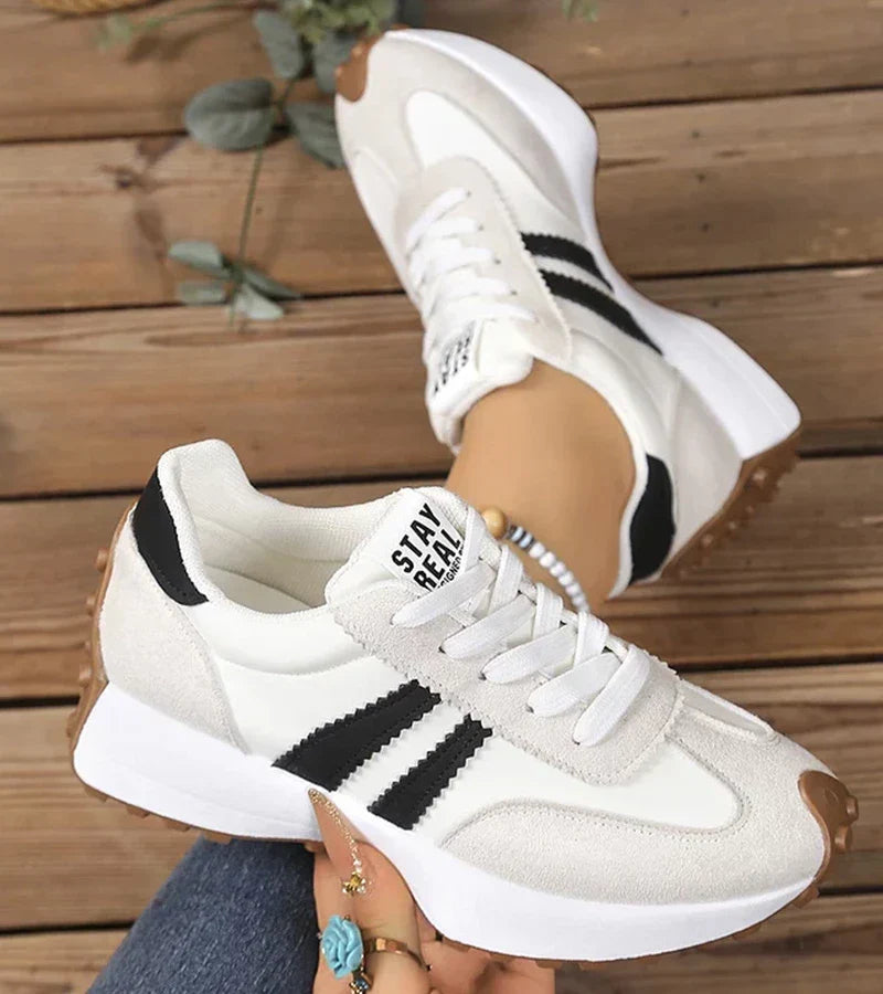 Women's panelled lace-up trainers with contrasting side stripes and raised white soles