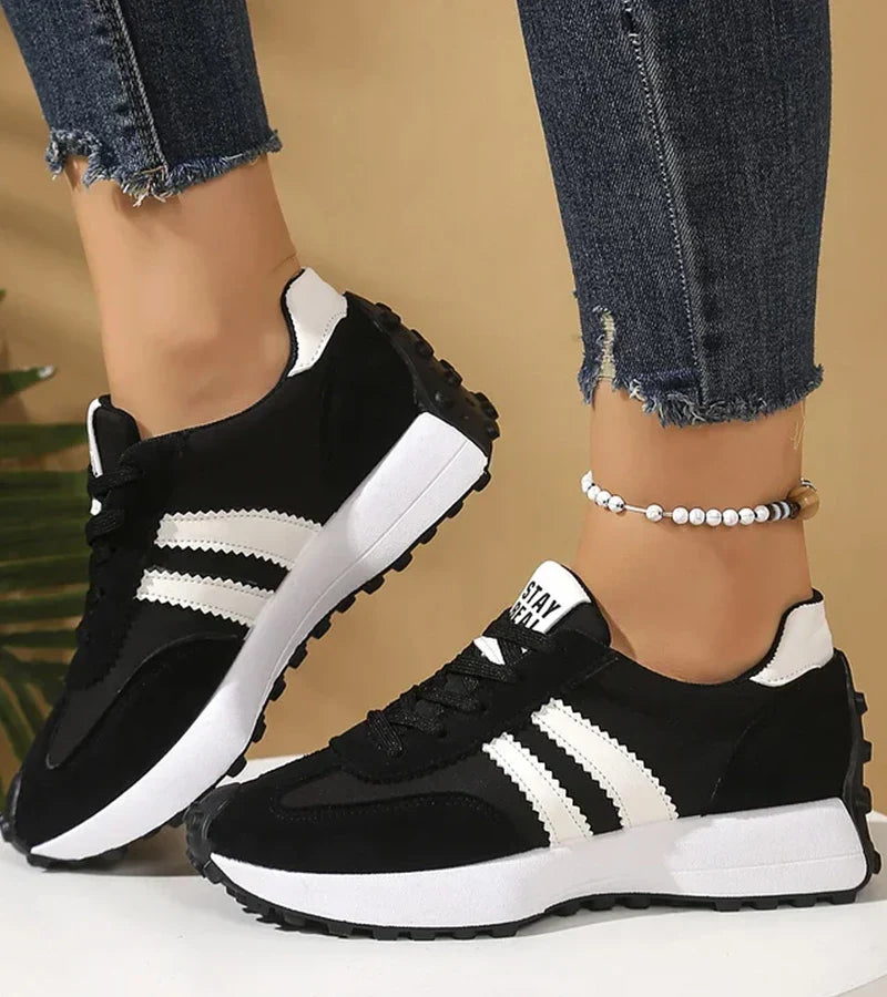 Women's panelled lace-up trainers with contrasting side stripes and raised white soles