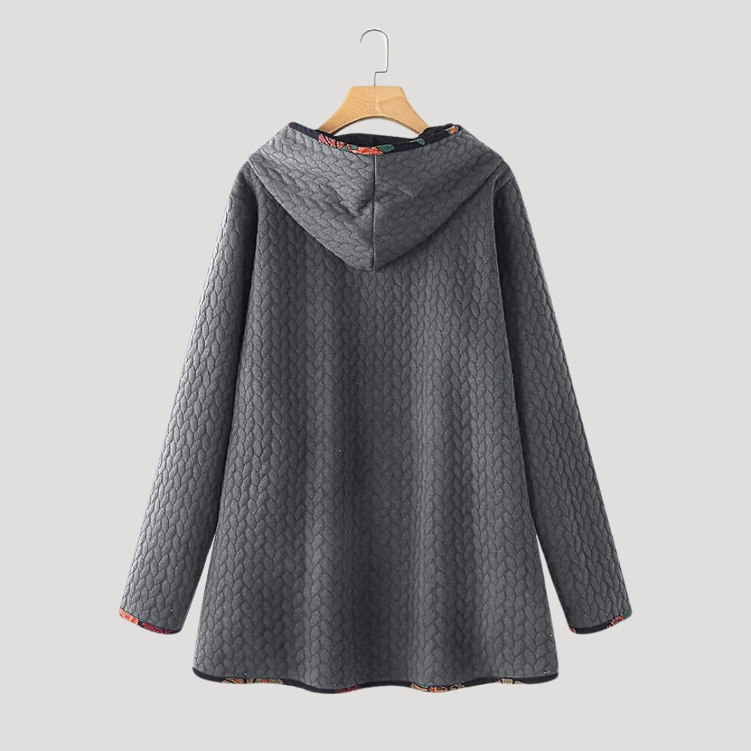Women's long hooded quilted winter coat with button front and patch pockets
