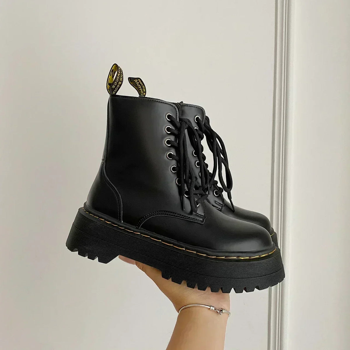 Women's black lace-up combat boots with chunky platform soles