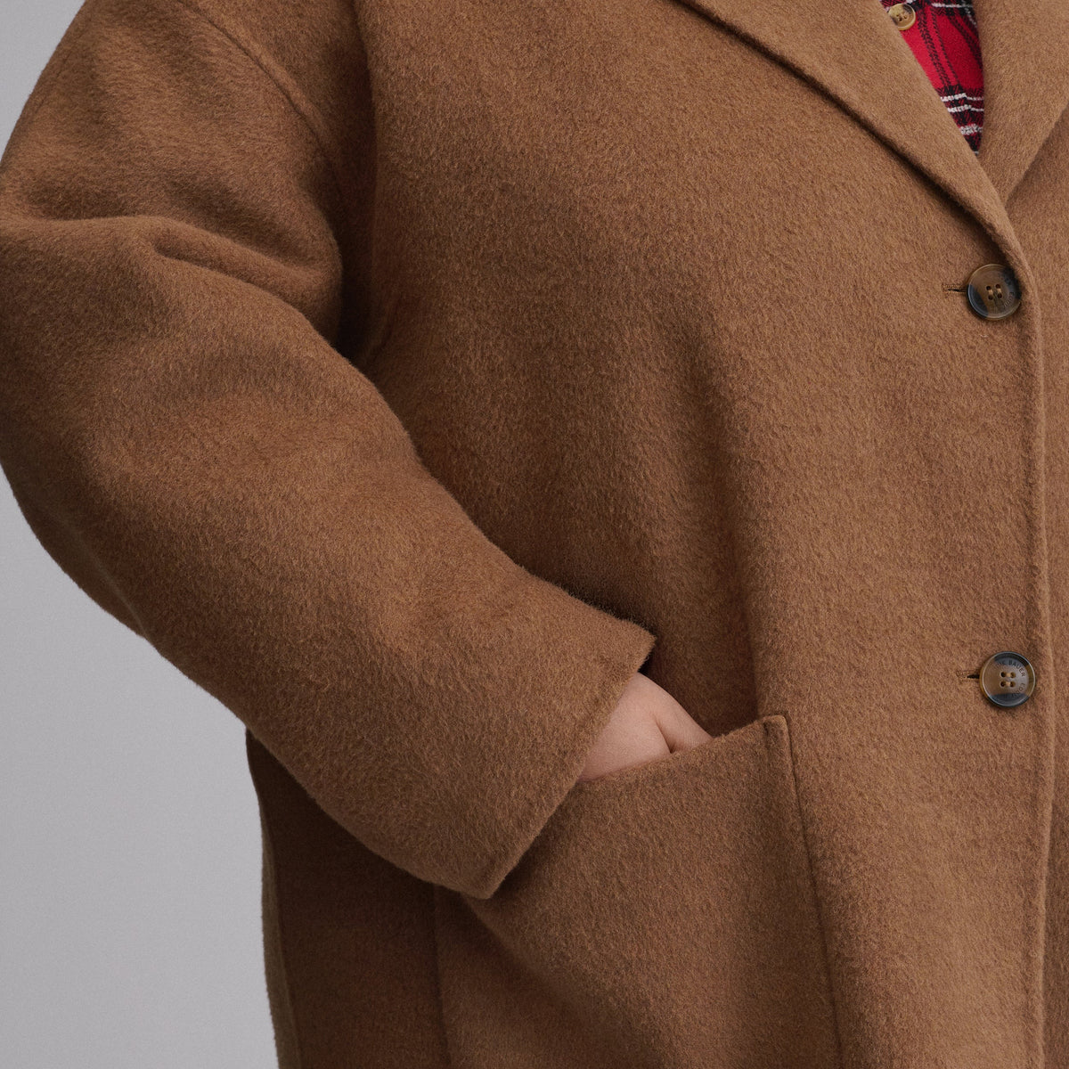 Women's camel long coat with notched lapels, button front and patch pockets
