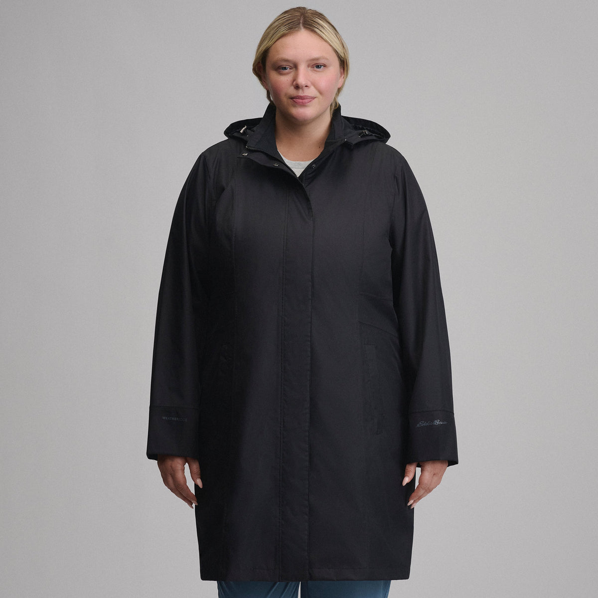 Women's long hooded waterproof trench coat with front zip and welt pockets