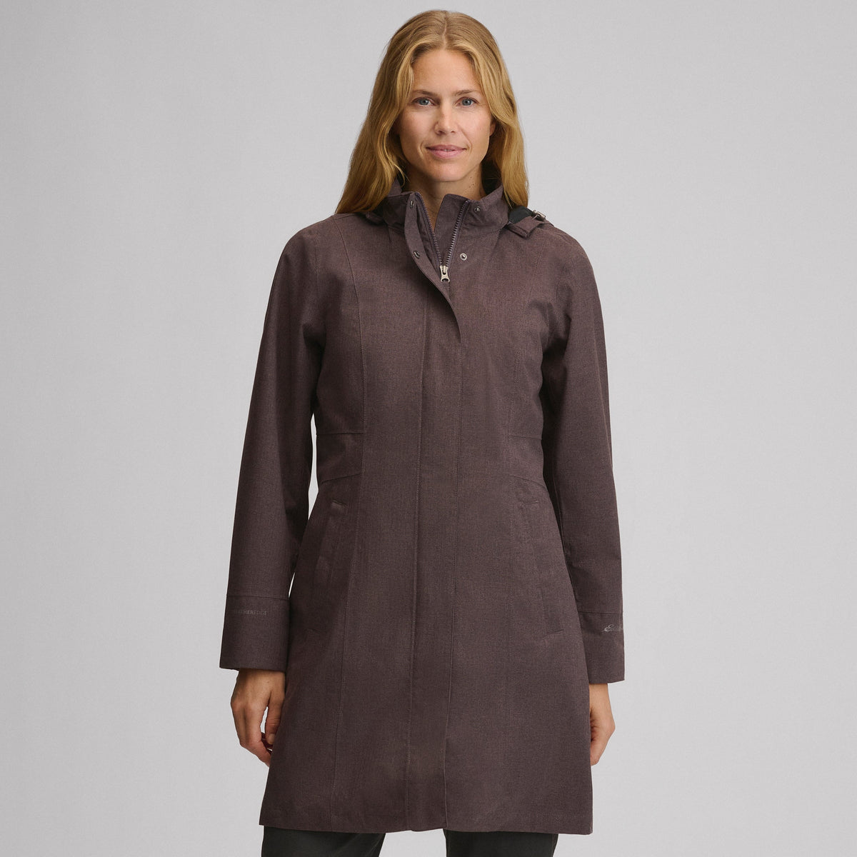 Women's long hooded waterproof trench coat with front zip and welt pockets