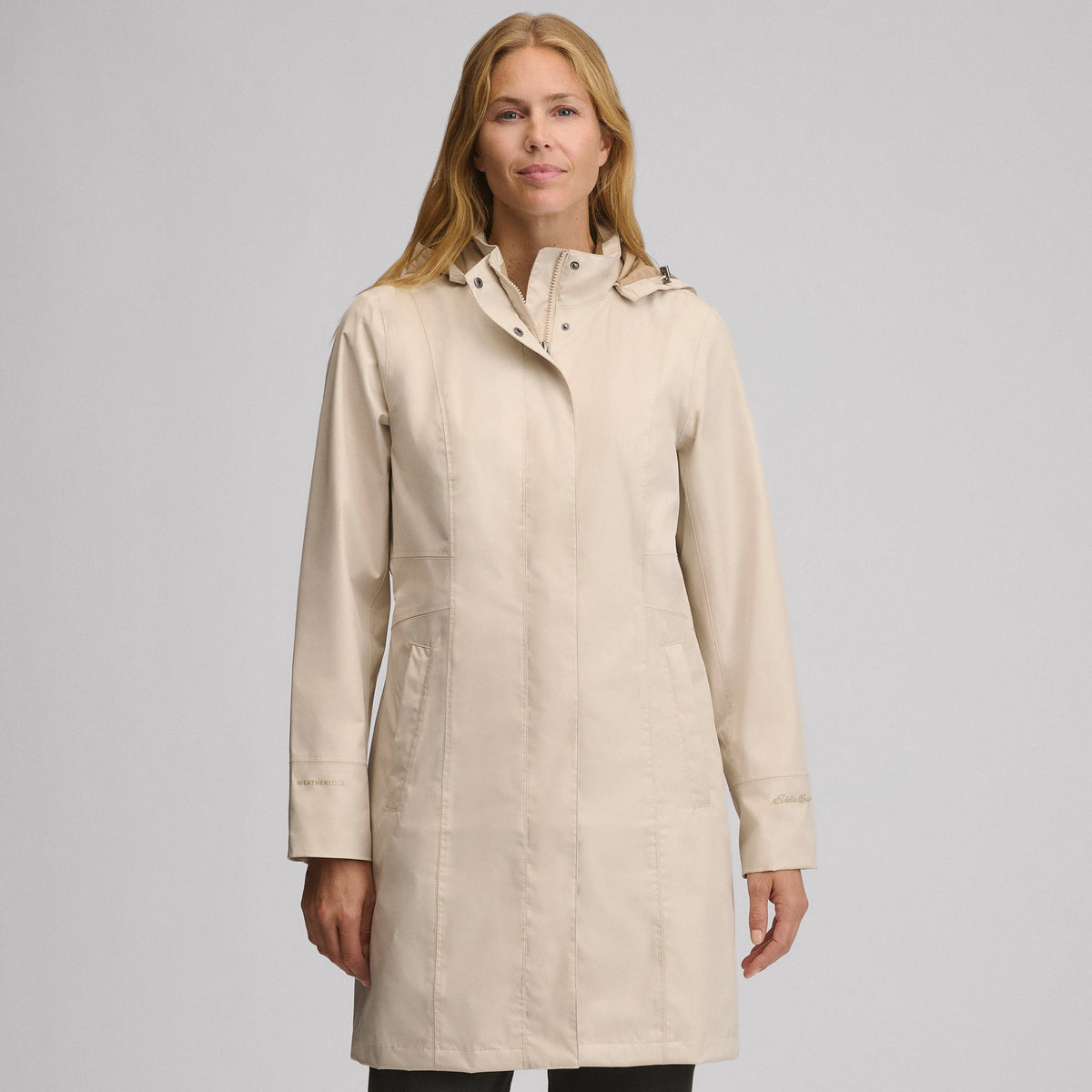 Women's long hooded waterproof trench coat with front zip and welt pockets