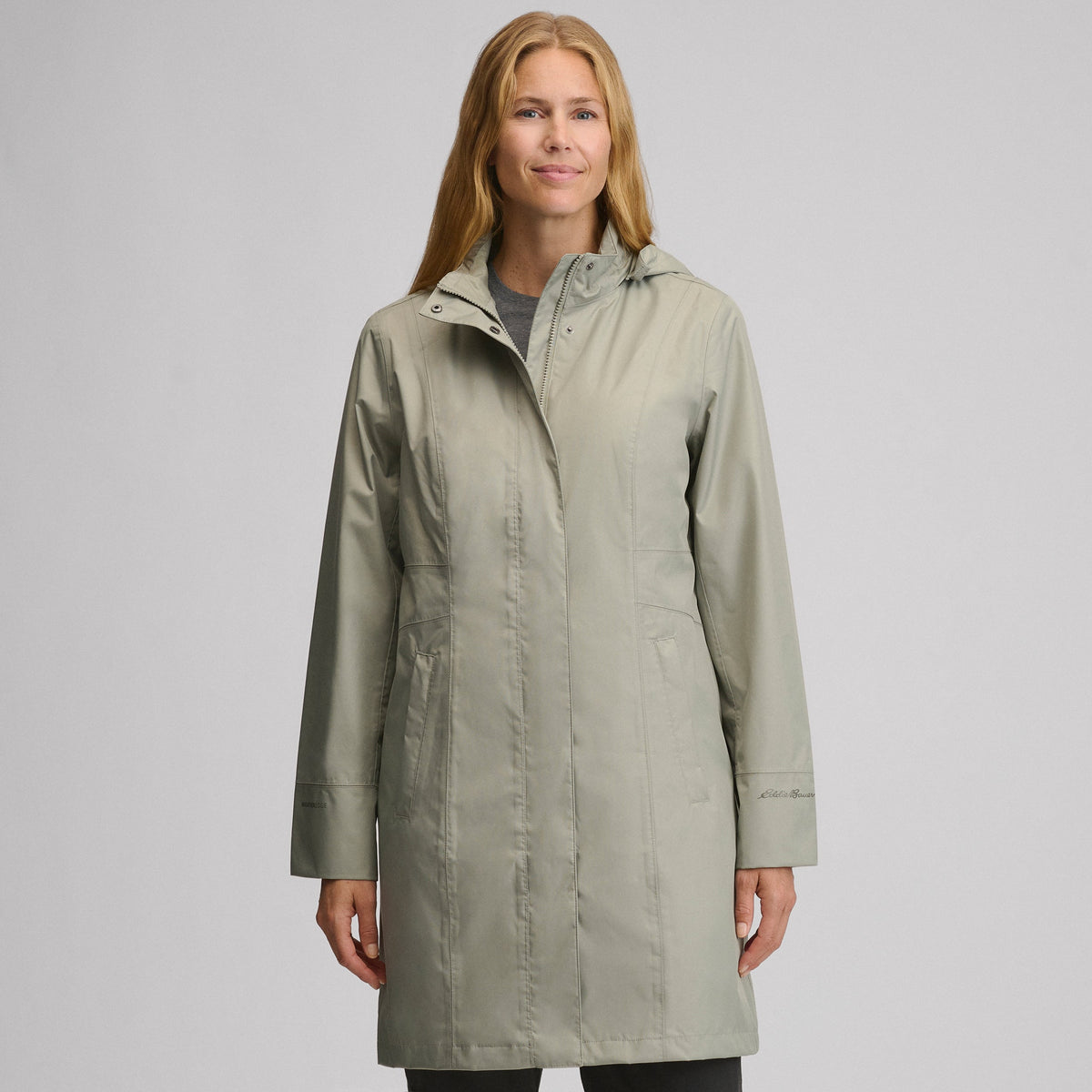 Women's long hooded waterproof trench coat with front zip and welt pockets