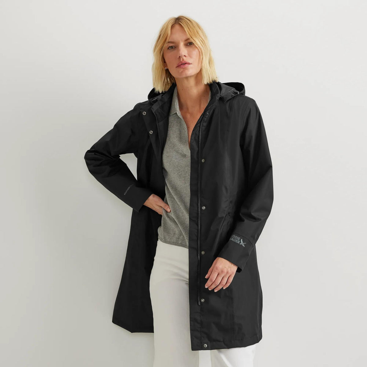 Women's long hooded waterproof trench coat with front zip and welt pockets