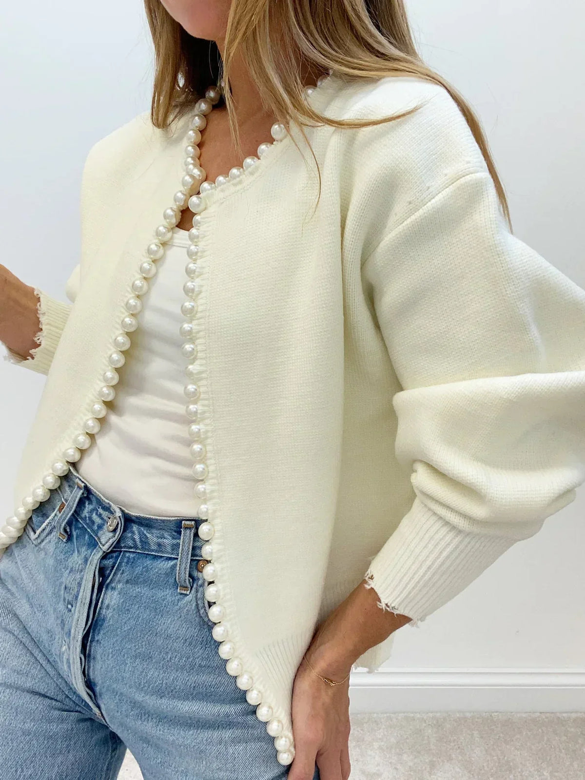 Women's open-front cardigan with pearl-style trim and long sleeves