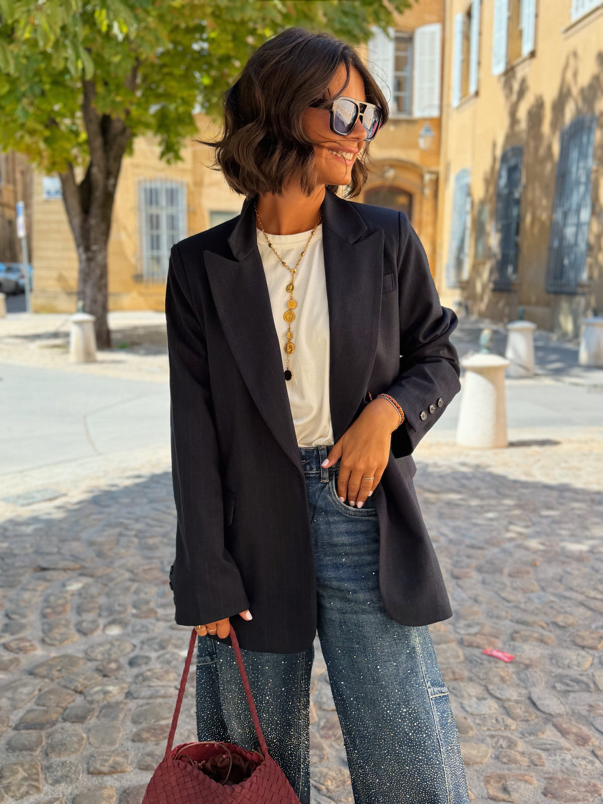 Women's black striped blazer with notched lapels and long sleeves