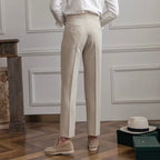 Women's high-waisted pleated straight-leg trousers with belt loops and long hems