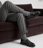 Men's glossy black penny loafers with rounded toes and low heels