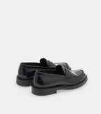 Men's glossy black penny loafers with rounded toes and low heels