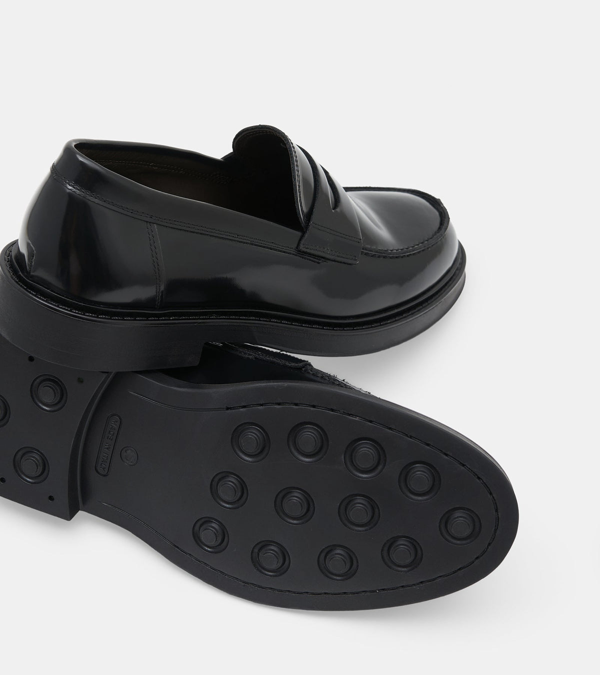 Men's glossy black penny loafers with rounded toes and low heels