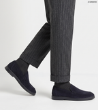 Men's navy blue slip-on loafers with penny strap detail and flat sole