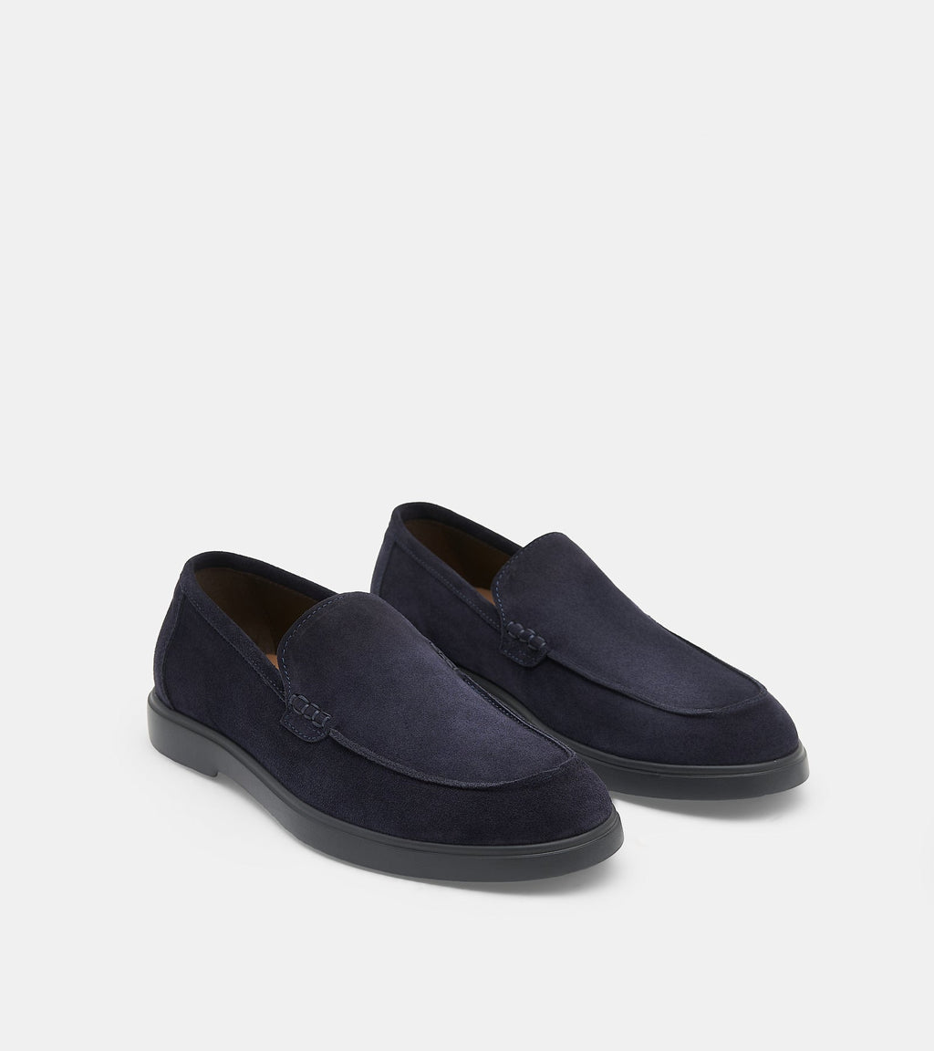 Men's navy blue slip-on loafers with penny strap detail and flat sole
