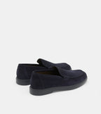 Men's navy blue slip-on loafers with penny strap detail and flat sole