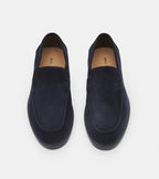 Men's navy blue slip-on loafers with penny strap detail and flat sole