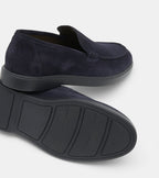 Men's navy blue slip-on loafers with penny strap detail and flat sole