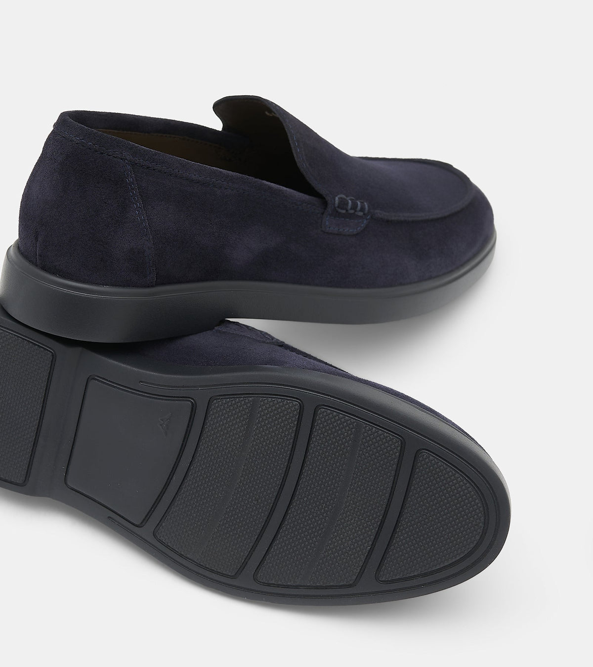 Men's navy blue slip-on loafers with penny strap detail and flat sole