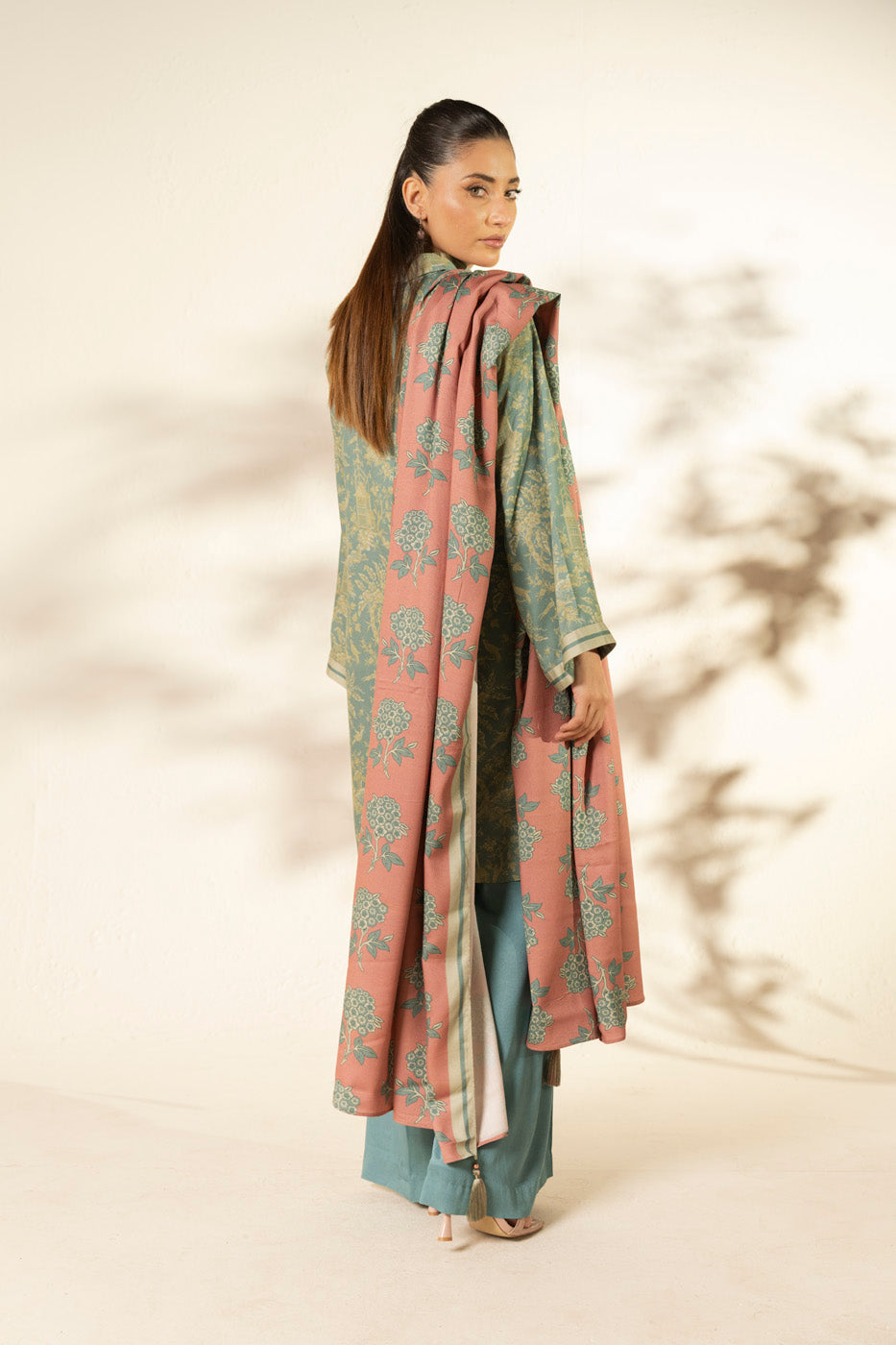Woman wearing a blue printed longline shirt with collared V-neck and pink patterned dupatta