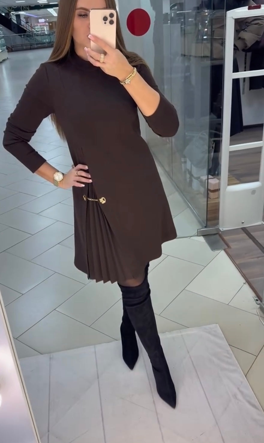 Women's plain long-sleeve mini dress with mock neckline, side pleats and decorative waist chain