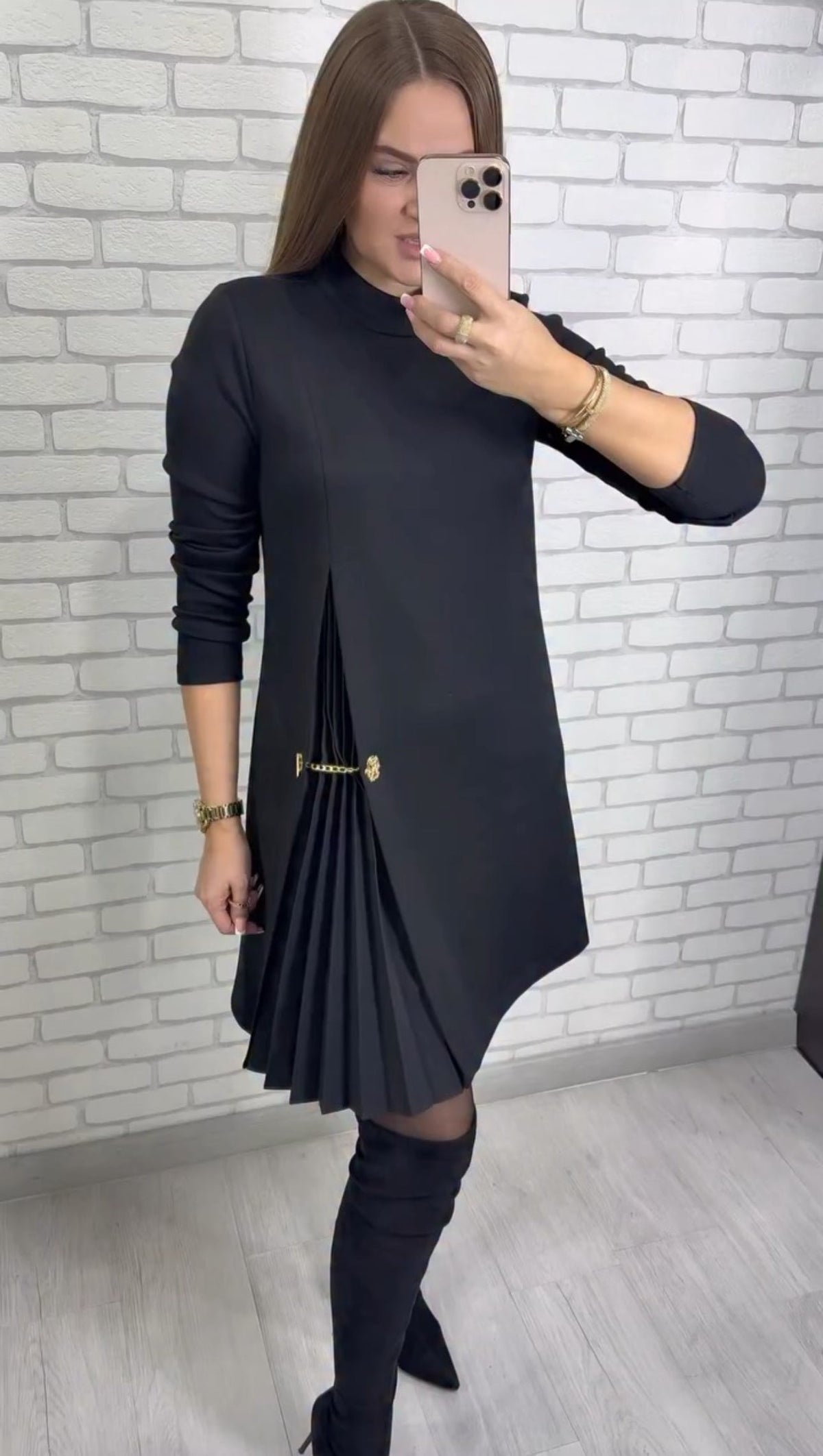 Women's plain long-sleeve mini dress with mock neckline, side pleats and decorative waist chain