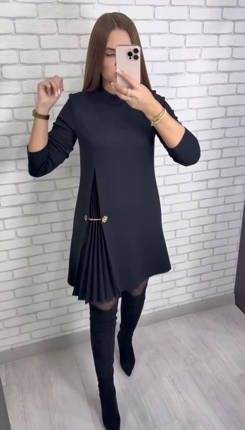 Women's plain long-sleeve mini dress with mock neckline, side pleats and decorative waist chain
