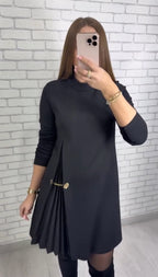 Women's plain long-sleeve mini dress with mock neckline, side pleats and decorative waist chain